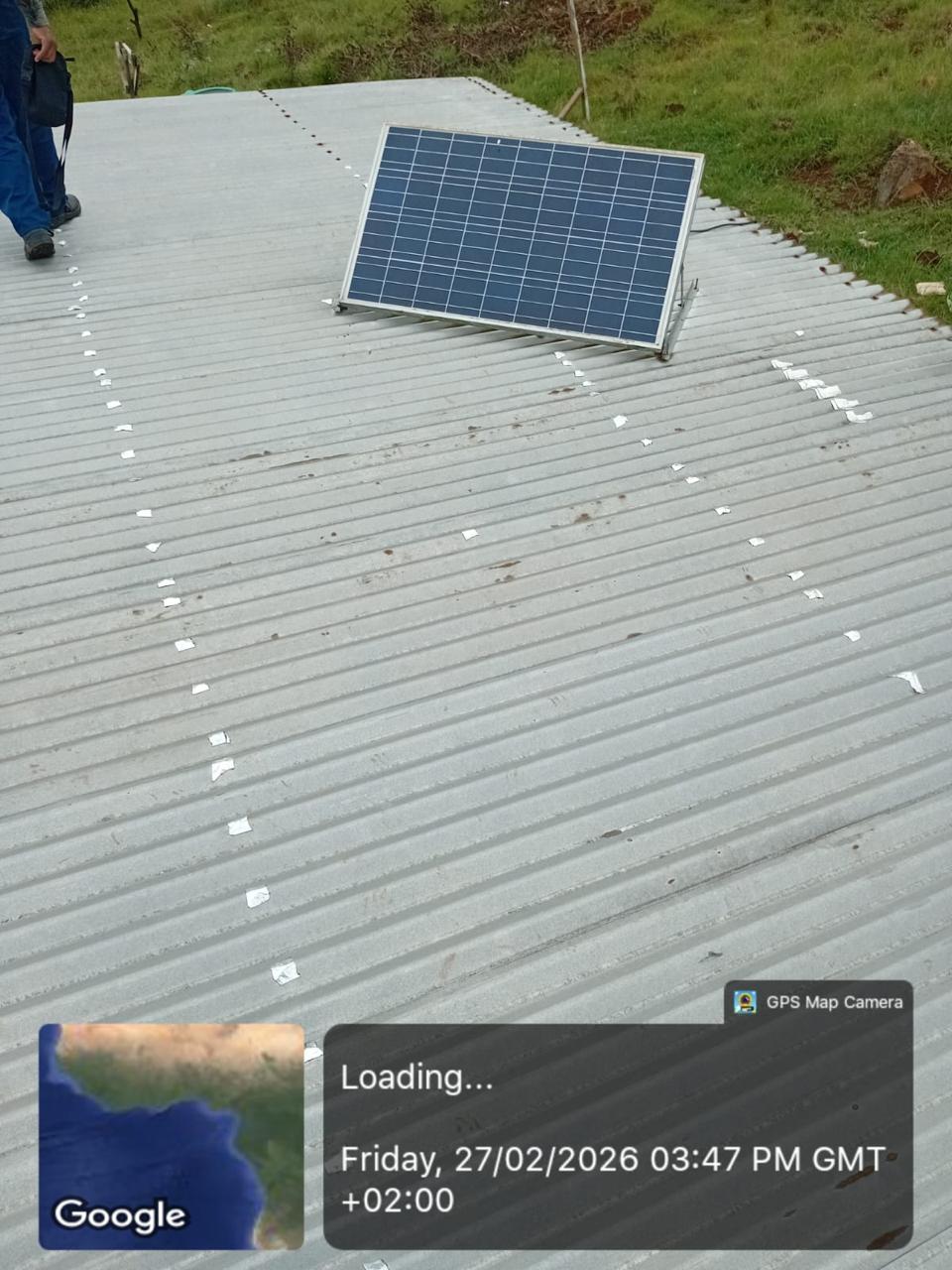 Roof-mounted solar panel positioned during installation.